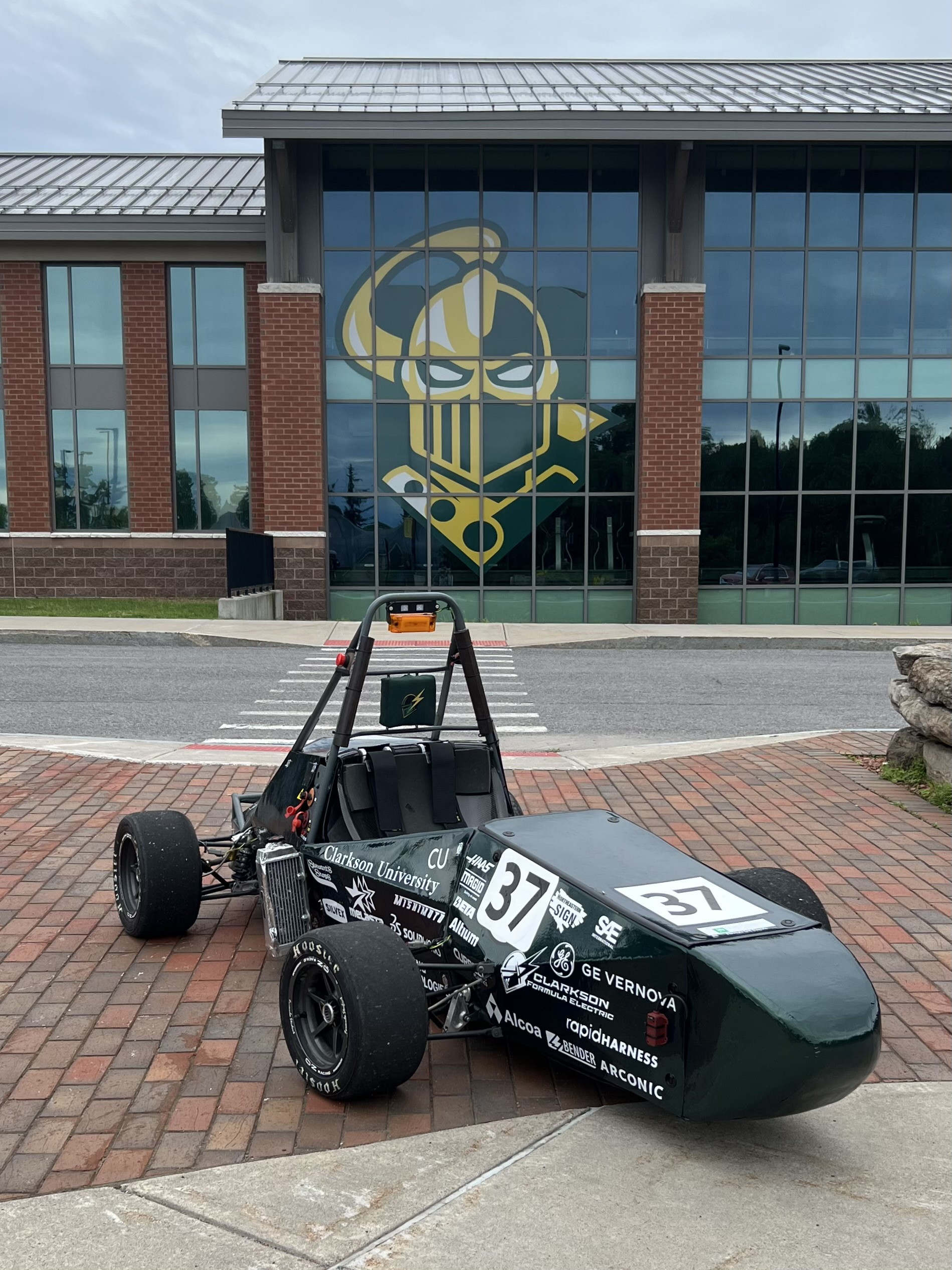 Clarkson Formula Electric car number 37 parked outside the engineering building